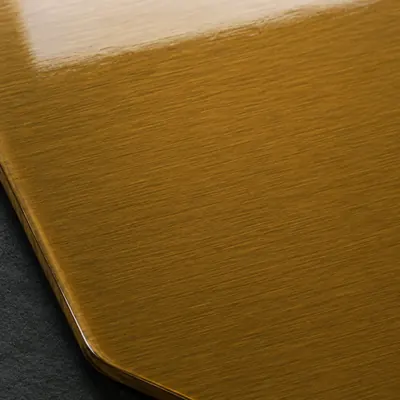 Amber translucent powder coating over brushed aluminium, macro